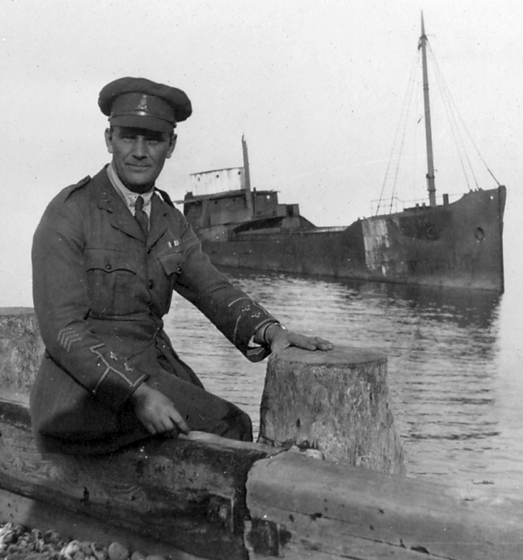 Reg on leave in Cromer, with the wreck of half of the Fernebo in the background.